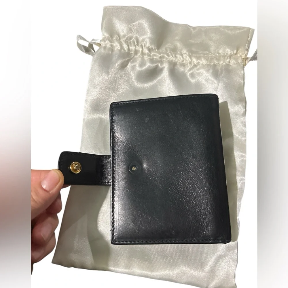 Authentic Ferragamo black leather trifold wallet gold with callouts